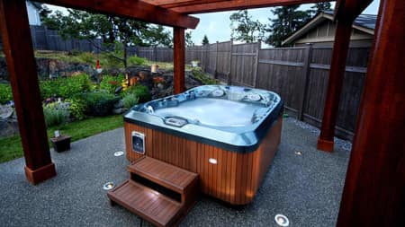 A hot tub surrounded by a garden